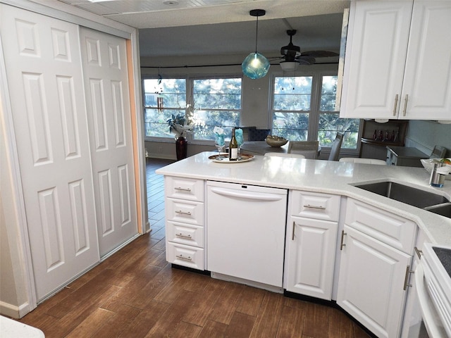 kitchen featuring dark hardwood / wood-style flooring, white cabinets, pendant lighting, and white appliances