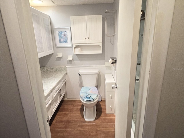 bathroom featuring hardwood / wood-style floors, vanity, and toilet