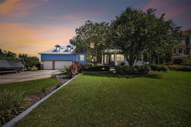 view of front of property featuring a lawn and a garage