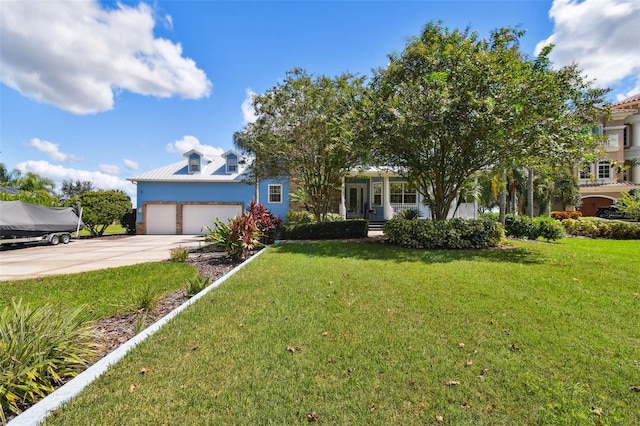 view of front of house featuring a front lawn and a garage