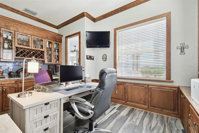 office with light hardwood / wood-style floors and ornamental molding