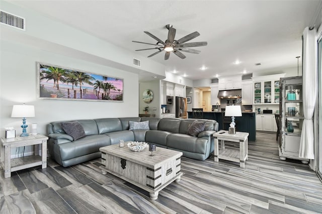 living room with ceiling fan and hardwood / wood-style floors