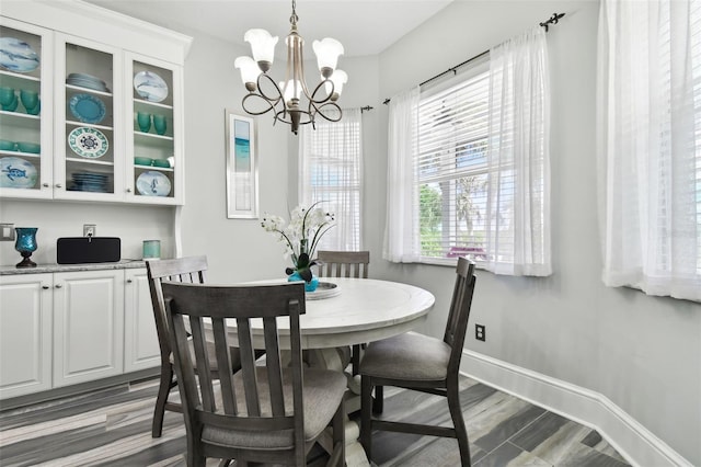 dining space with a chandelier, dark hardwood / wood-style floors, and a healthy amount of sunlight