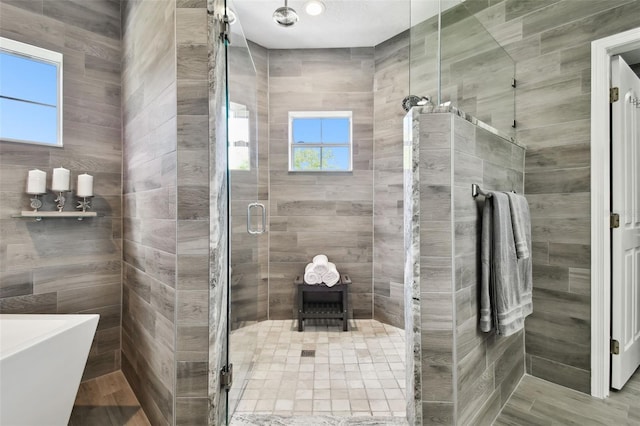 bathroom with shower with separate bathtub