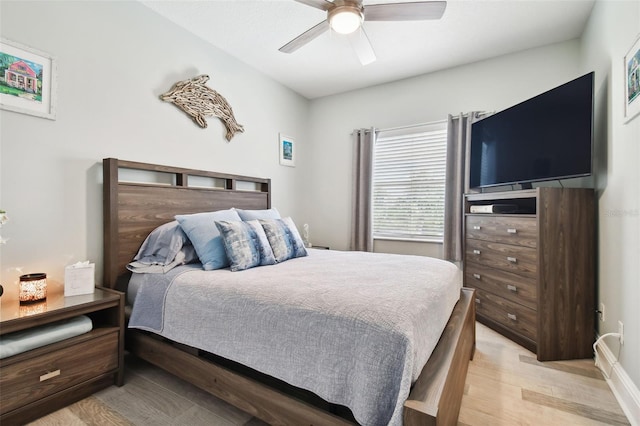 bedroom with light hardwood / wood-style floors and ceiling fan