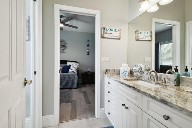 bathroom featuring wood-type flooring, vanity, and ceiling fan