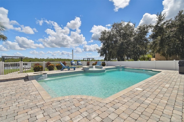 view of swimming pool featuring a patio and an in ground hot tub