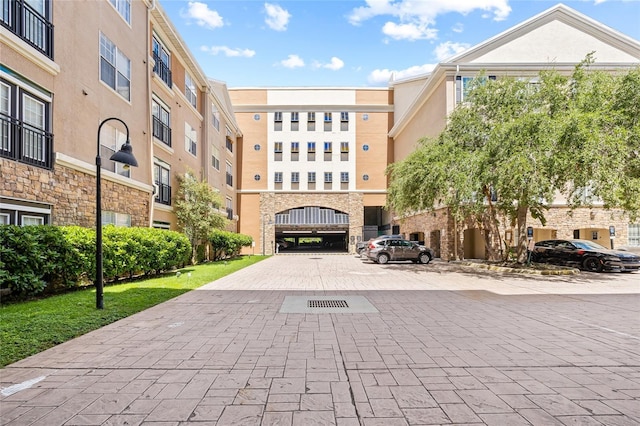 4221 W Spruce St Unit 1424, Tampa, FL 33607 - view of building exterior with uncovered parking