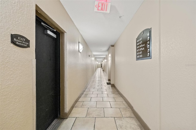 hall featuring light tile patterned floors