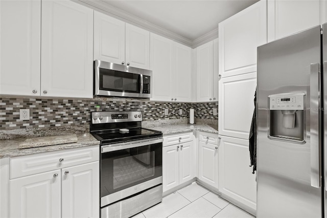 kitchen with light tile patterned flooring, white cabinetry, decorative backsplash, appliances with stainless steel finishes, and light stone countertops