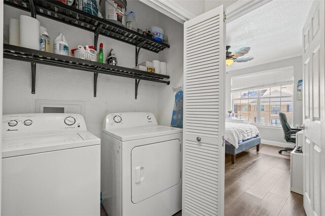 4221 W Spruce St Unit 1424, Tampa, FL 33607 - laundry room with separate washer and dryer, dark wood-style floors, a ceiling fan, and crown molding