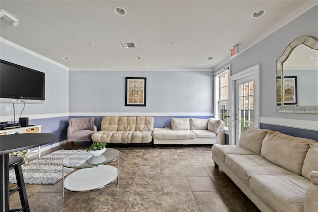 living room featuring tile patterned flooring, ornamental molding, and french doors