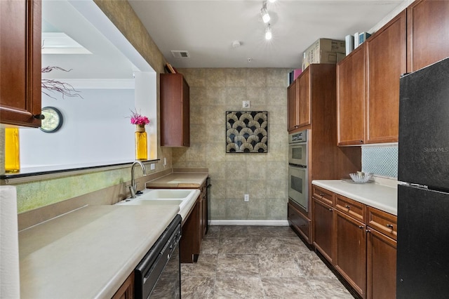 kitchen with ornamental molding, sink, and black appliances