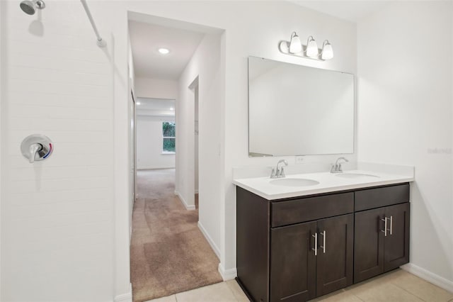 bathroom with walk in shower, vanity, and tile patterned floors