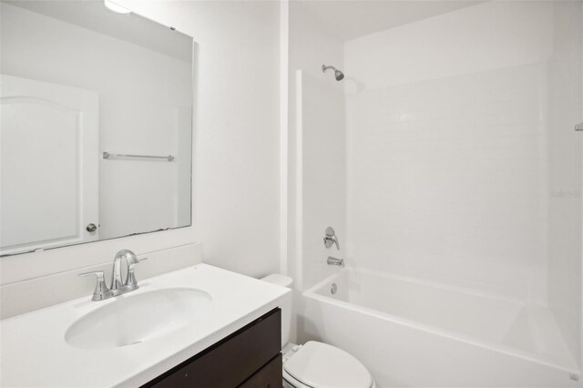 full bathroom with tub / shower combination, vanity, and toilet