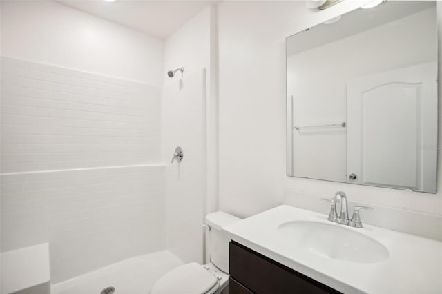 bathroom with a shower, vanity, and toilet