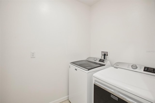 clothes washing area with washing machine and dryer