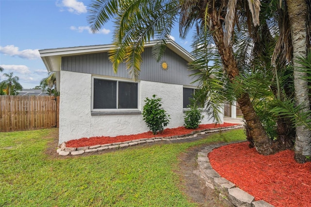 view of side of home with a lawn