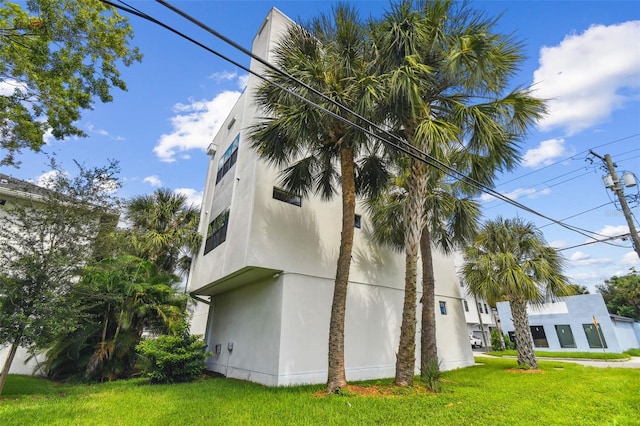 view of side of home with a lawn