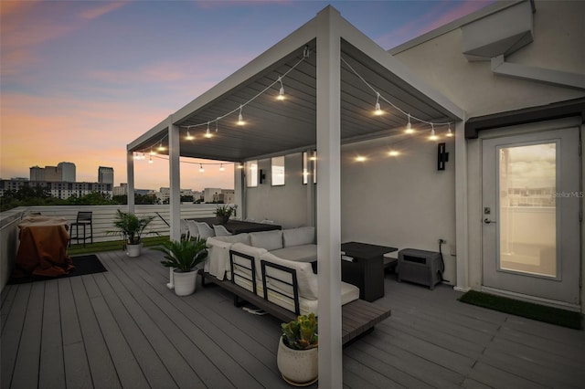 deck at dusk featuring an outdoor hangout area