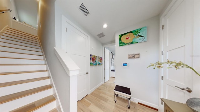 stairs with hardwood / wood-style flooring