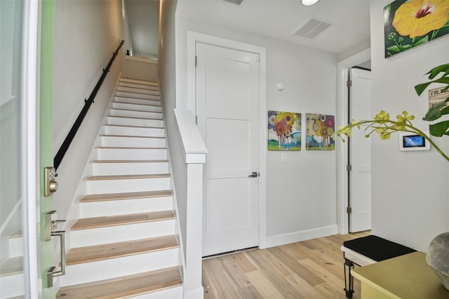 stairway with hardwood / wood-style floors