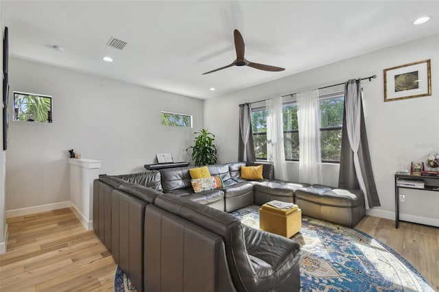 living room with light wood-type flooring and ceiling fan