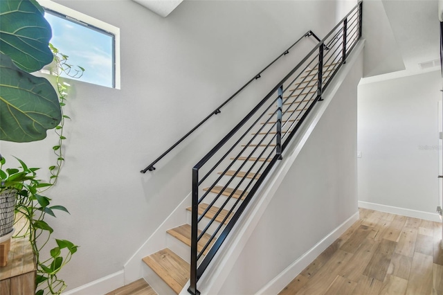 staircase featuring hardwood / wood-style flooring