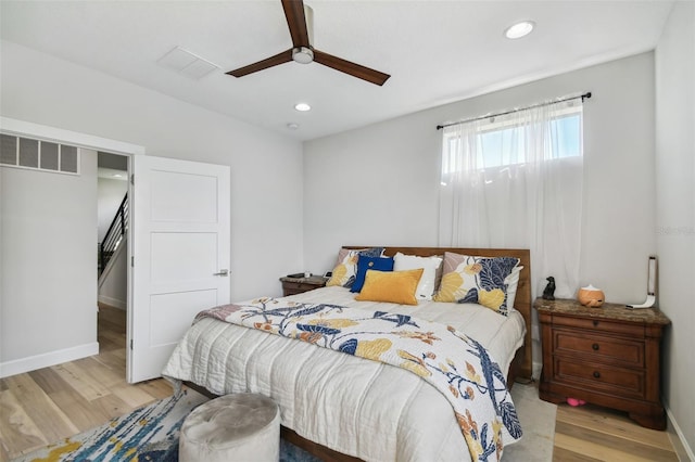 bedroom with ceiling fan and light hardwood / wood-style flooring