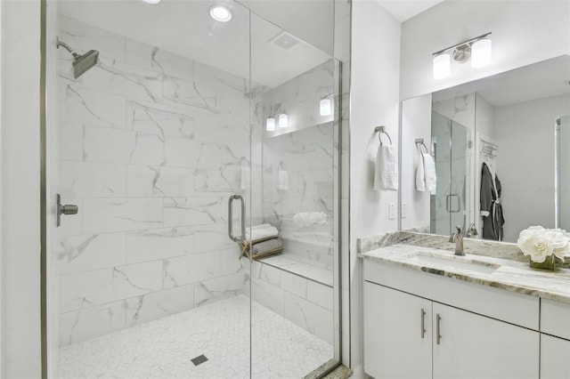 bathroom featuring vanity and an enclosed shower