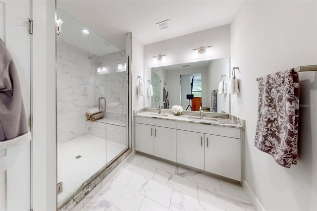 bathroom with vanity and a shower with door