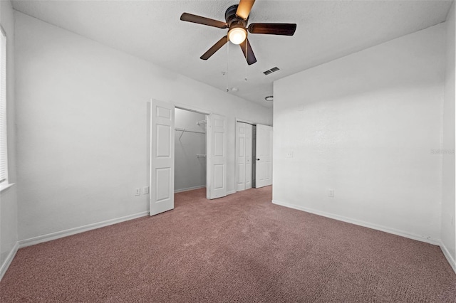 unfurnished bedroom featuring carpet and ceiling fan