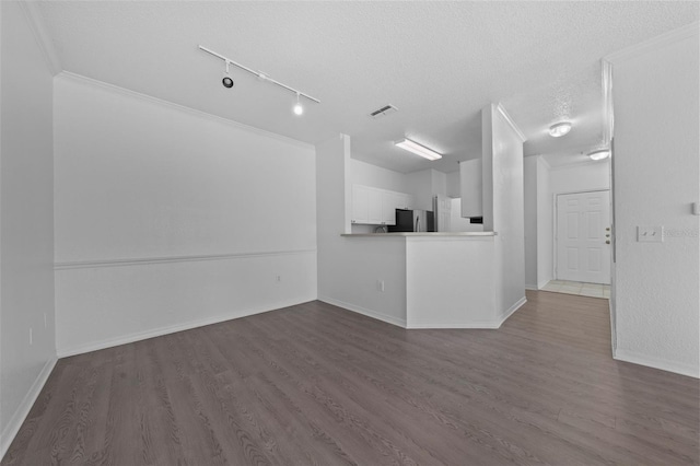 unfurnished living room featuring hardwood / wood-style flooring, crown molding, and a textured ceiling