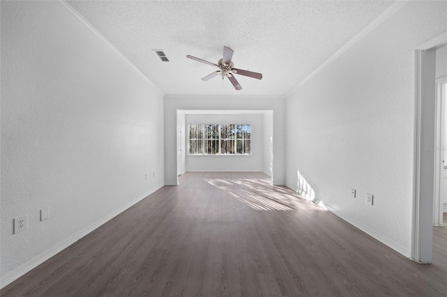 empty room featuring a textured ceiling, ceiling fan, dark hardwood / wood-style floors, and ornamental molding