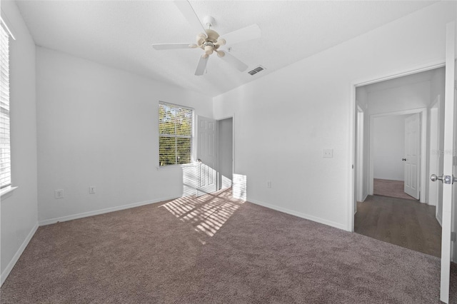 empty room featuring dark colored carpet and ceiling fan