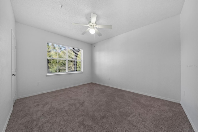 unfurnished room with ceiling fan, carpet floors, and a textured ceiling