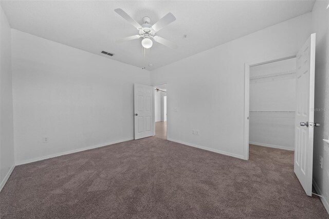 unfurnished bedroom with ceiling fan, a closet, and carpet floors