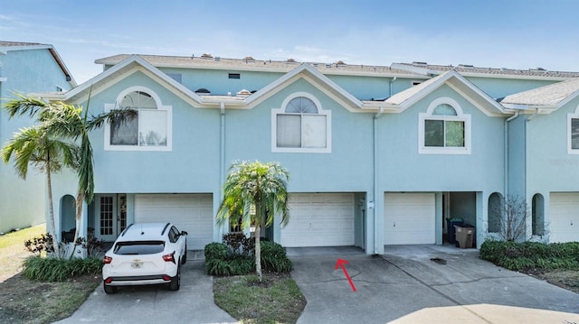 townhome / multi-family property featuring a garage