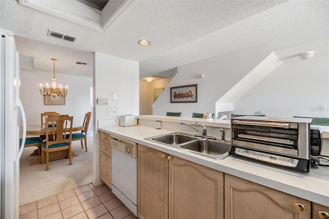 kitchen with light carpet, a textured ceiling, sink, decorative light fixtures, and white appliances