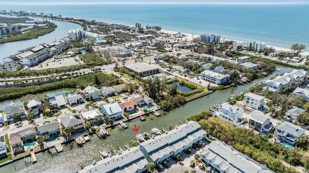 birds eye view of property with a water view and a city view