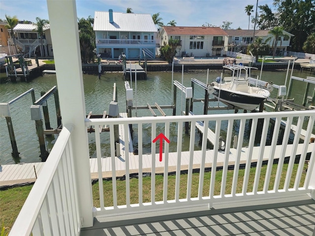 view of dock featuring a residential view, a water view, and boat lift