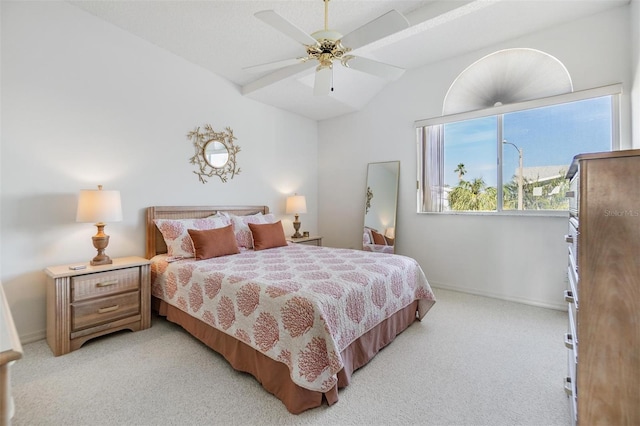 bedroom featuring vaulted ceiling, baseboards, a ceiling fan, and light colored carpet