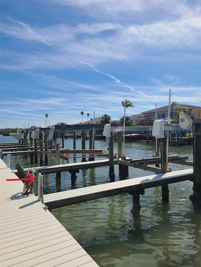 dock area with a water view and boat lift