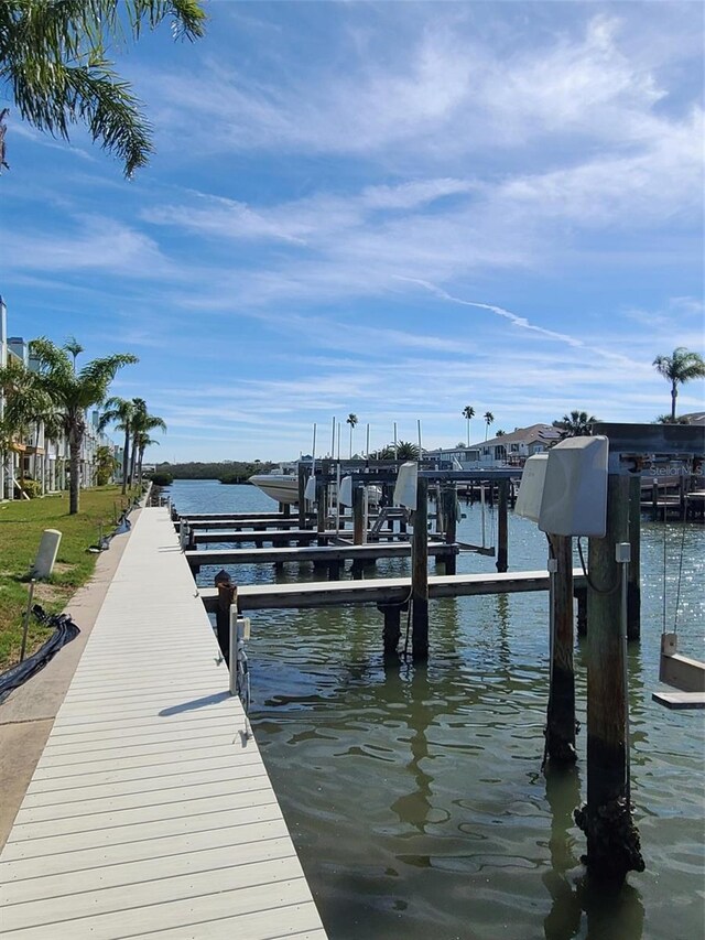 dock area with a water view and boat lift