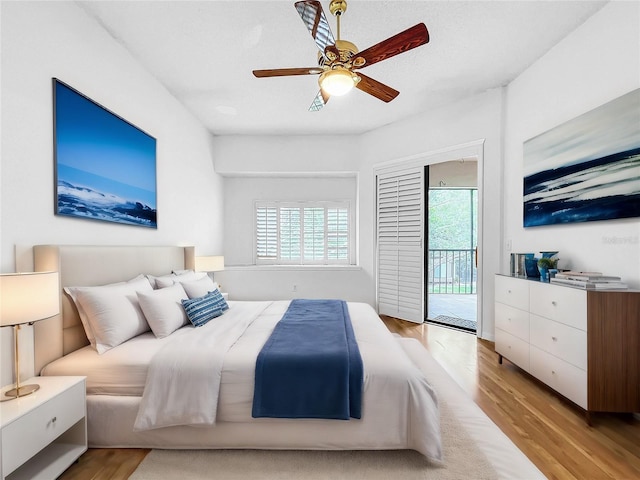 bedroom with multiple windows, access to outside, light hardwood / wood-style floors, and ceiling fan