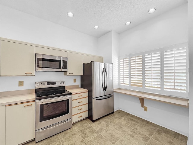 kitchen featuring a textured ceiling and stainless steel appliances