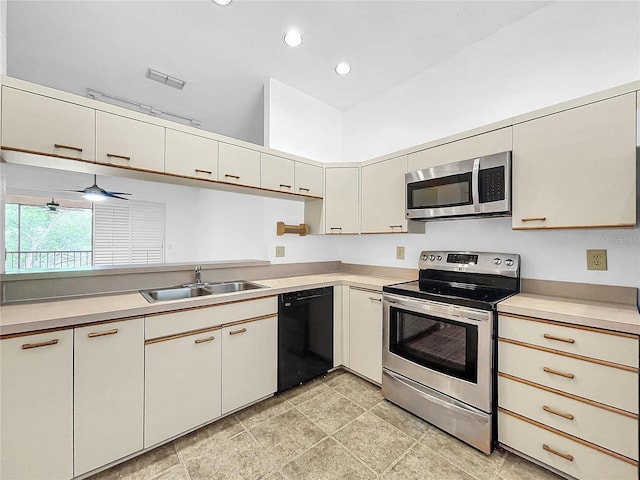 kitchen featuring stainless steel appliances, ceiling fan, and sink