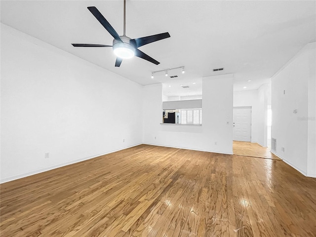 unfurnished living room featuring crown molding, ceiling fan, light hardwood / wood-style flooring, and track lighting