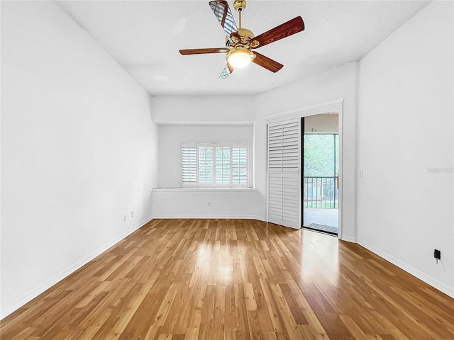 spare room with light hardwood / wood-style floors, ceiling fan, and a textured ceiling