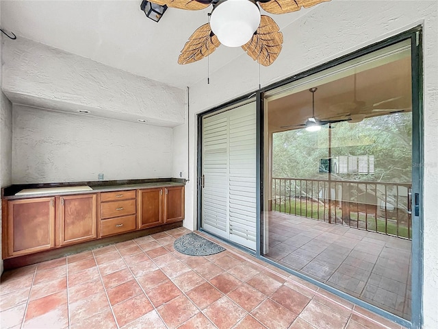 interior space with ceiling fan